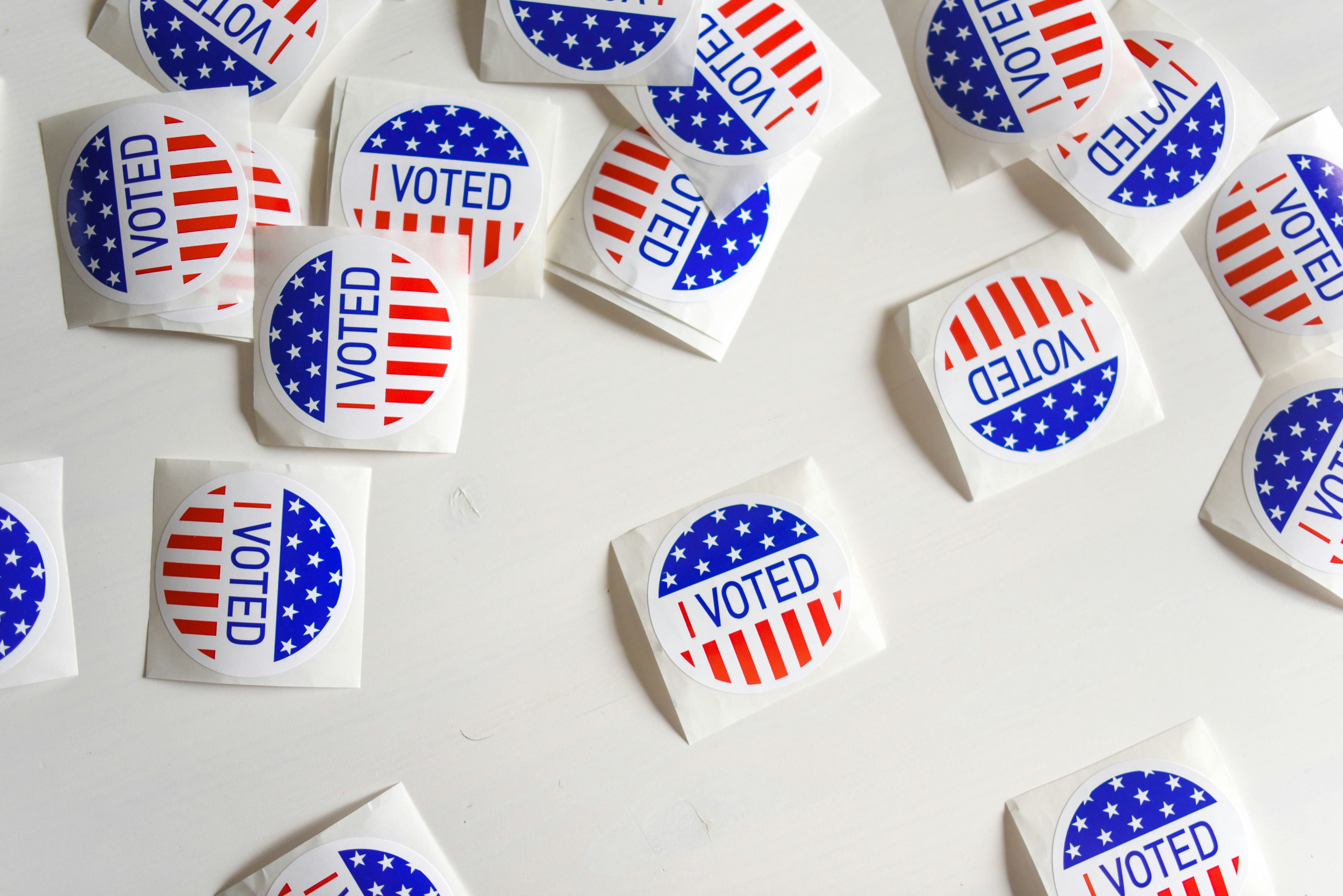I Voted stickers and ballots on a table